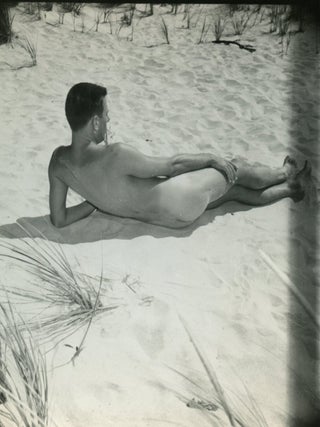 Item #9231 An original vintage photograph of Paul Cadmus, reclining nude on beach. PaJaMa, Jared...